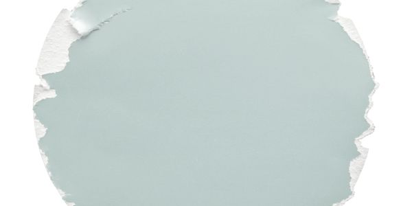 Torn circular piece of light blue paper with rough white edges.