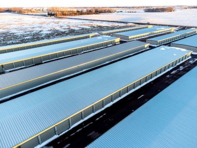 Rows of large storage or industrial buildings covered in snow.