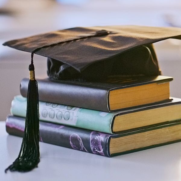 Graduation cap on top of a stack of books.