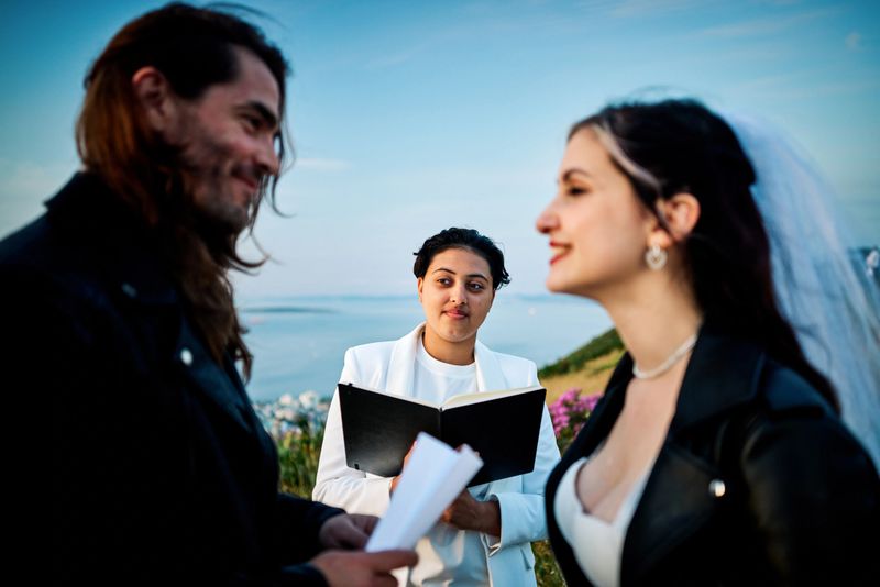 In the warm embrace of dusk, a bride and groom committing vows to each other, celebrating their love and matrimony.