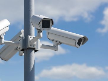 Multiple security cameras mounted on a pole.