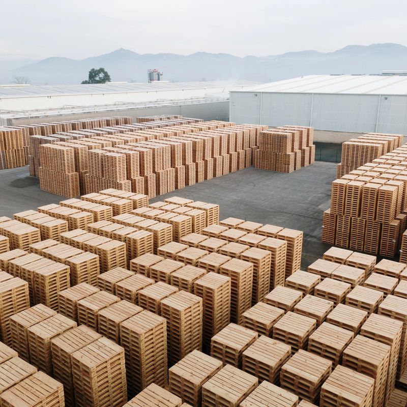 A large number of stacked pallets in an industrial area