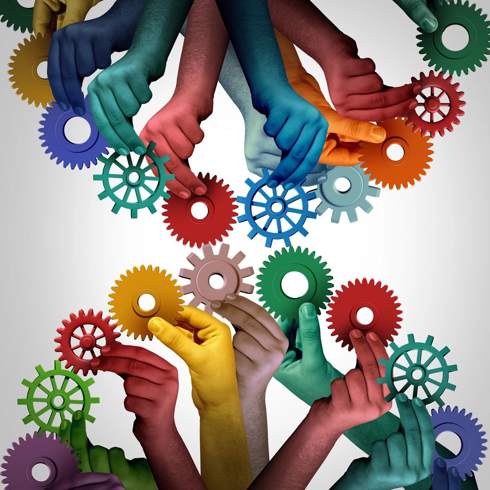 Colorful hands holding gears, symbolizing teamwork and collaboration.