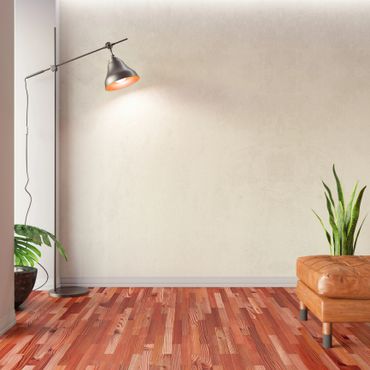 Minimalist room corner with floor lamp, leather ottoman, and plants.