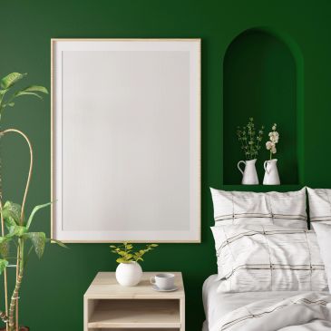 Blank framed poster in a green-themed bedroom.