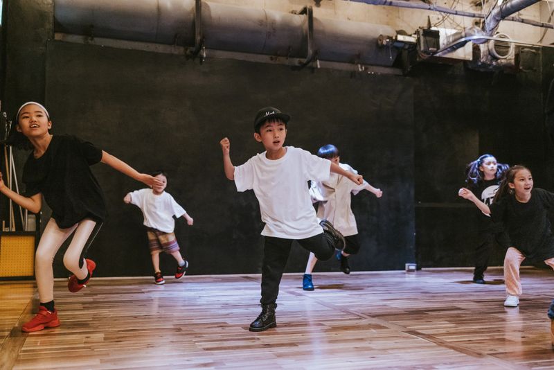 Japanese kids of various ages engage in a hip-hop breakdance session, full of joy and passion for the art form.