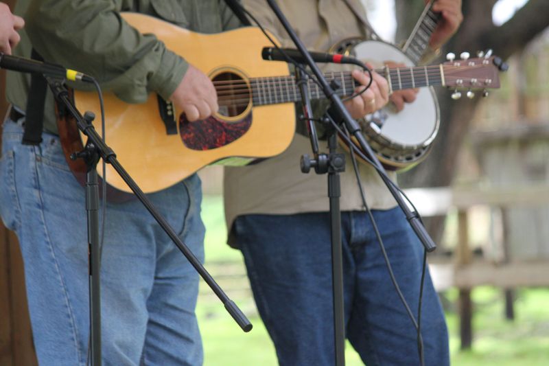 Guitar and Banjo Player Musicians performing outdoors.