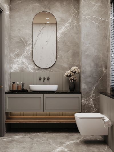 Modern bathroom with marble walls and floating vanity.