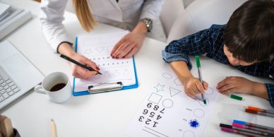 Child and adult doing cognitive tests with shapes and numbers.