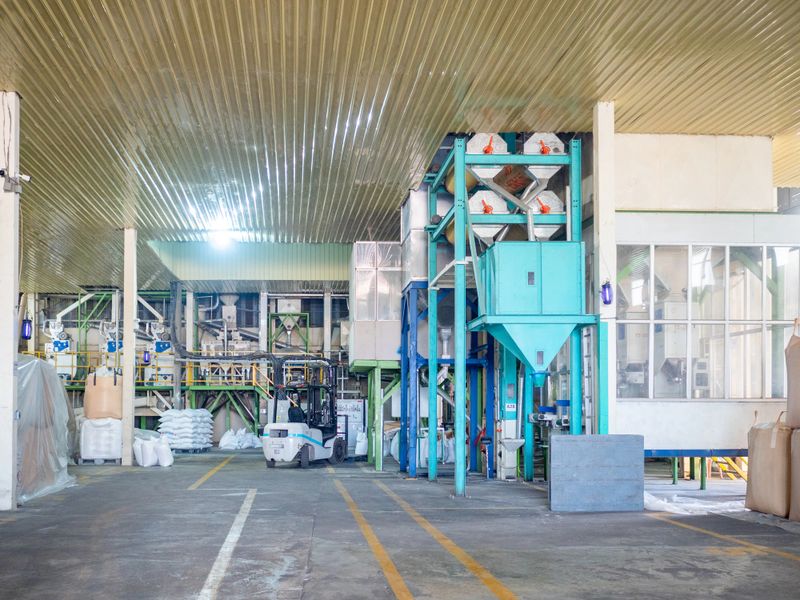 Rice milling factory interior, front view of paddy drying machine. Post-harvest processing of paddy rice for export.