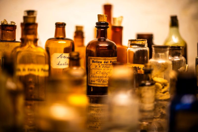 old medicine bottles behind the ancient display case bottles with ancient brown writings in Cuzco Inca city on the Peruvian highlands