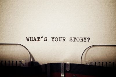 Text on paper asks, "What's your story?"