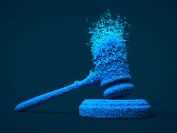 A blue gavel disintegrating into particles on a dark background.