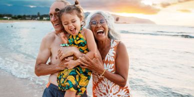 Happy family enjoying sunset at the beach.