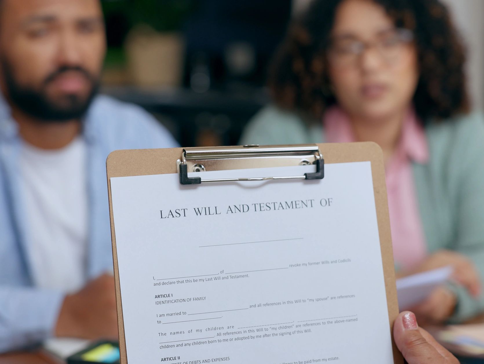 Document of last will and testament on clipboard.