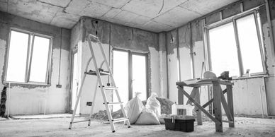 Room under construction with ladder and tools.