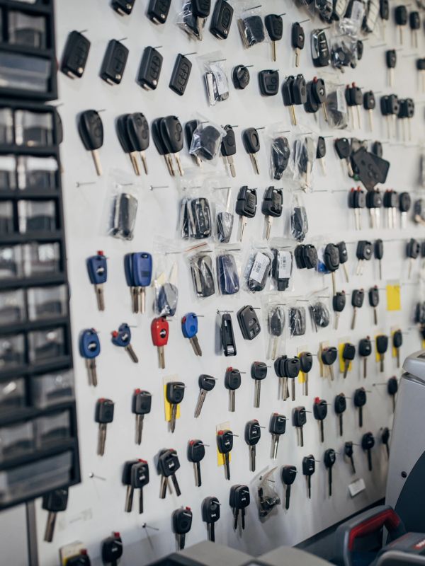 Wall display of various car keys organized in rows.