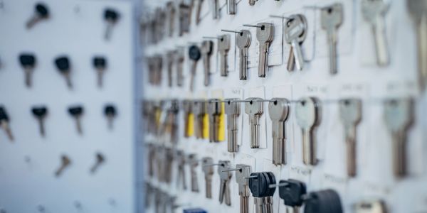 A wall display of various keys organized on hooks.