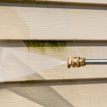Soft washing a house