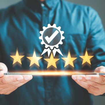 Person holding a tablet with floating five-star rating and approval badge.