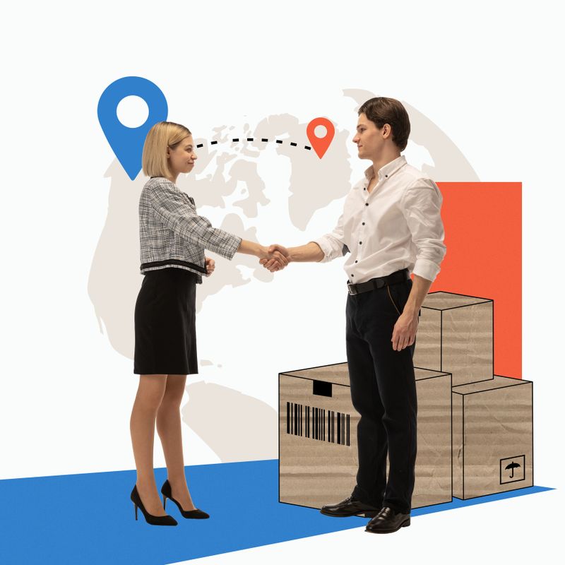 Man and woman shaking hands in front of cardboard boxes with world map on background. Global logistics collaboration. Concept of logistics, cargo companies, worldwide shipping and delivery services