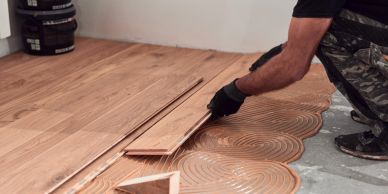 Person installing wooden flooring.