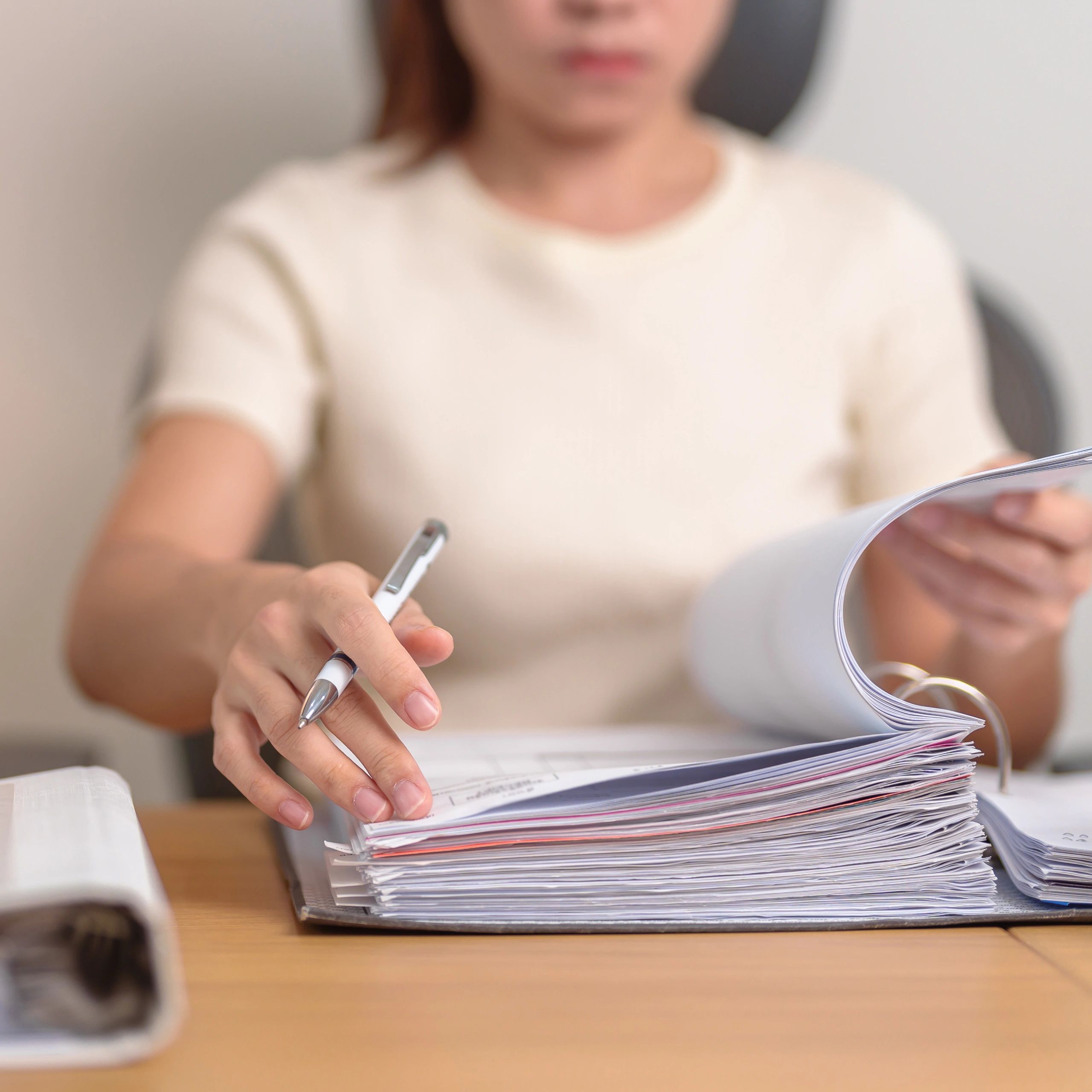 Image of a woman checking an accounting ledger . accounting and bookkeeping for plumbing and HVAC co