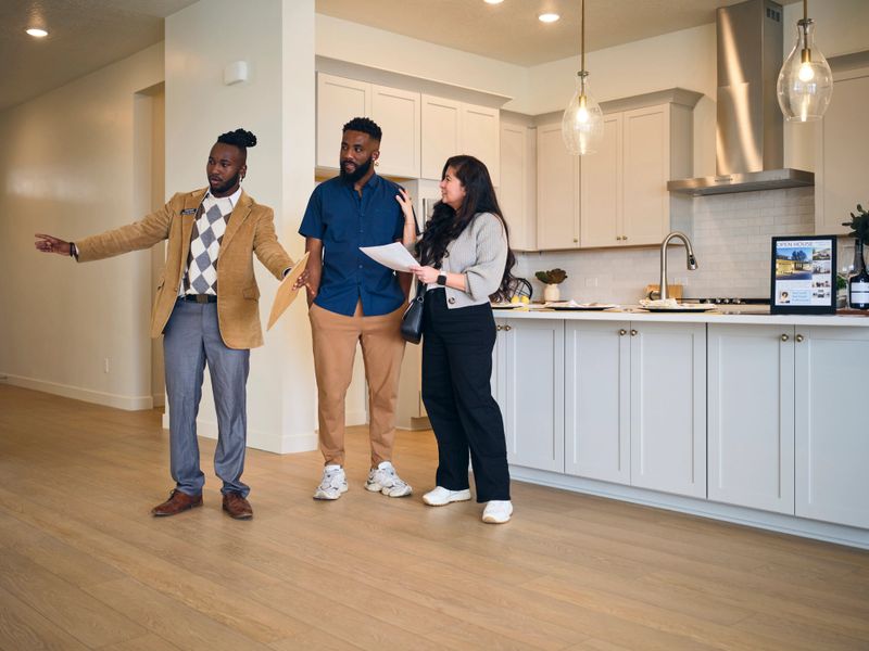 A professional real estate agent, showing a new home to prospective buyers.