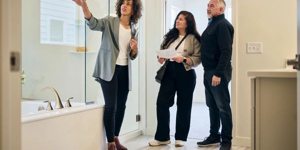 Consultant showing homeowner rental listing options and tenant screening in Vancouver