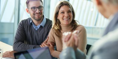 Couple smiling during a meeting.