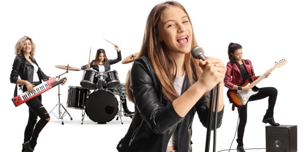 Young female rock band performing with instruments and singing.