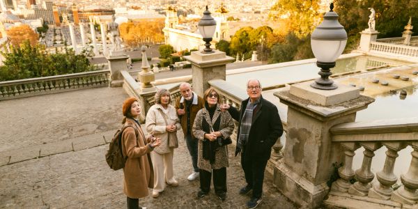 Group of elderly tourists exploring a historic site.