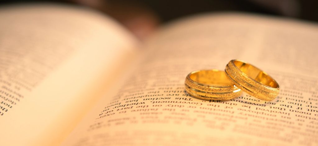 Two gold rings on an open book.