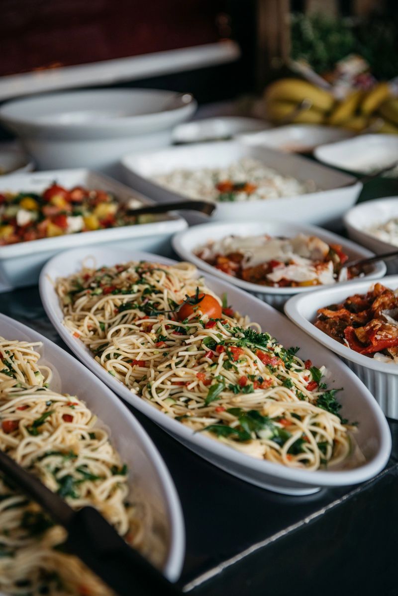 A pasta dish with assorted vegetables elegantly plated for a wedding reception