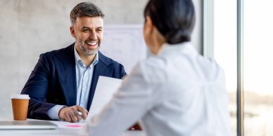 Two professionals having a positive conversation in an office.