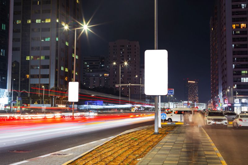 City traffic with red lines, road, cars, buildings and mock-up billboard at night. Rush Hour