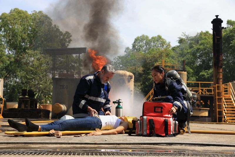Firefighters are assisting a fire victim who has encountered an accident in Advance Fire Fighter Practice or Training