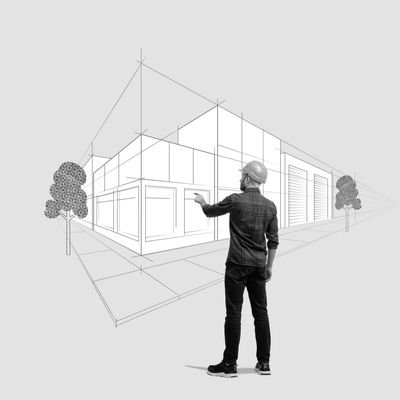 Architect in helmet visualizing building plans in 3D.
