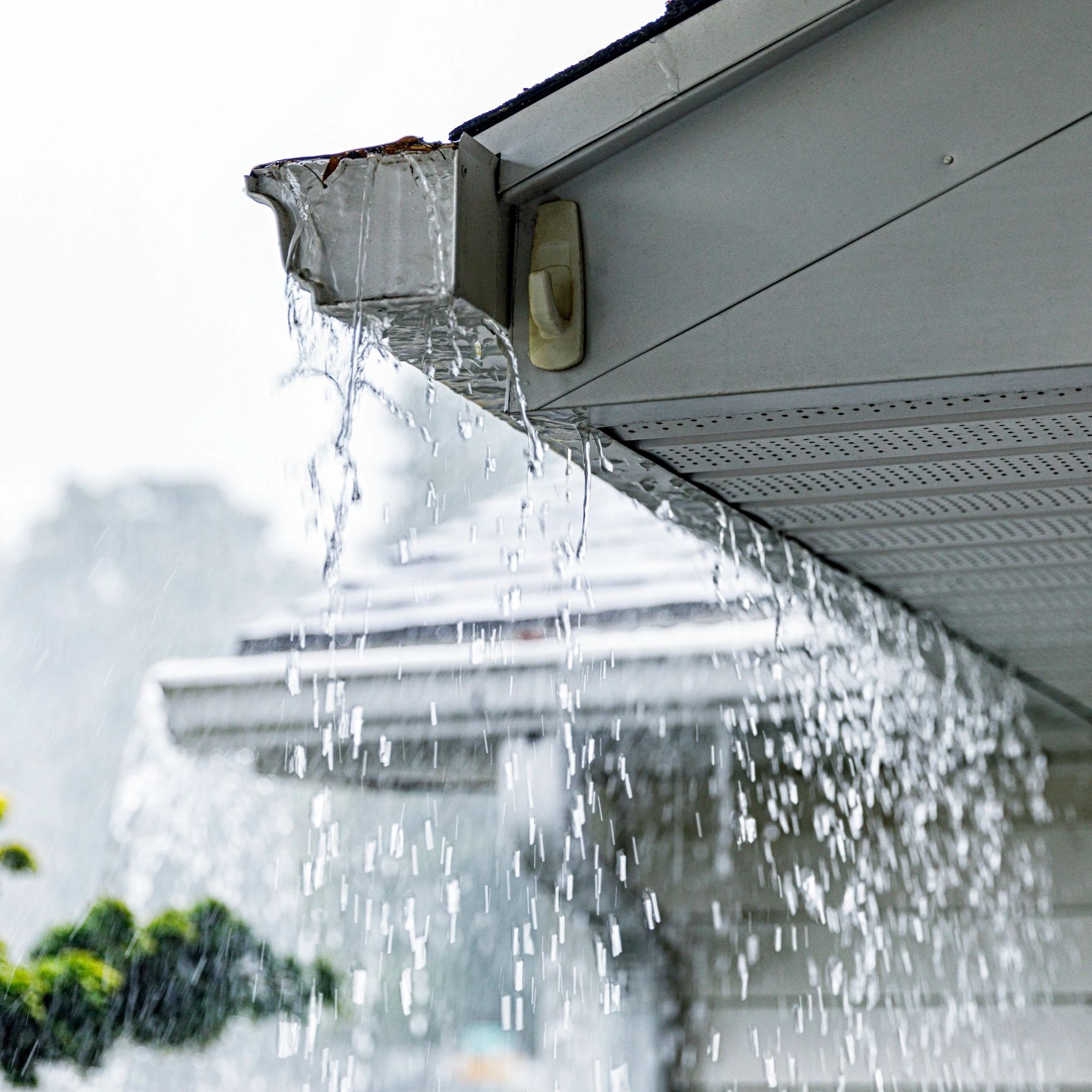 Charlotte house gutters overflowing in a heavy rain