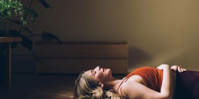 Woman lying down peacefully indoors.