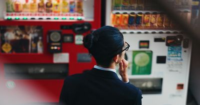 Person looking at vending machines, contemplating what to select.