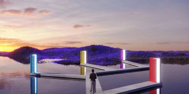Person standing near illuminated pillars on water at sunset.