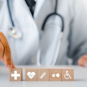 Healthcare professional arranging medical symbol blocks.