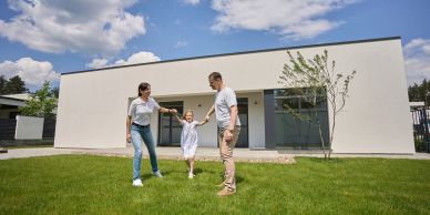 Family enjoying time outside their modern home.