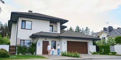 Family walking out of a modern house.