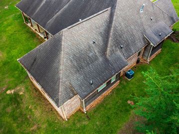 Aerial view of a house roof with chalk markings on shingles.