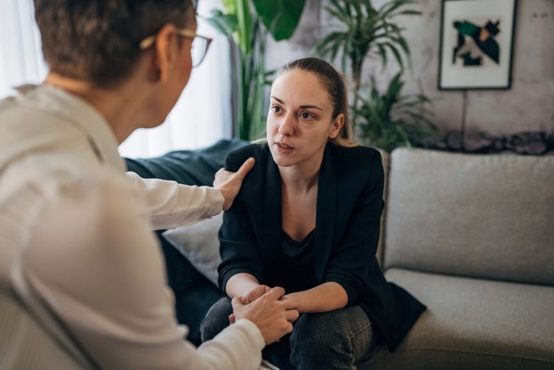 A therapist and patient are captured in a moment of connection, their hands joined in mutual support. The scene epitomizes empathy, understanding, and the silent strength that defines the therapeutic relationship.