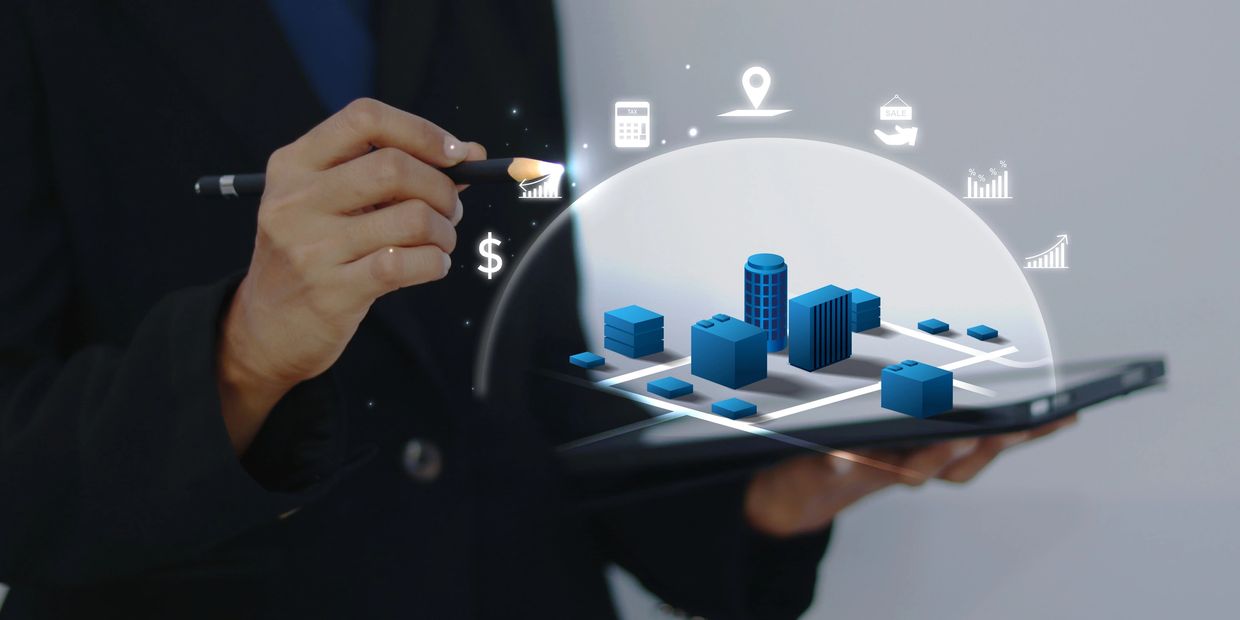 Person interacts with a digital city model and financial icons using a stylus on a tablet.