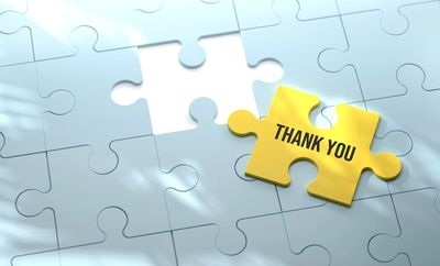Yellow puzzle piece with 'Thank You' next to a missing piece in a white puzzle.