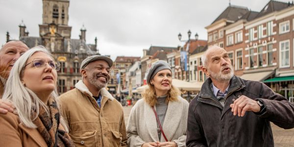 Group of seniors sightseeing in a historic city square.